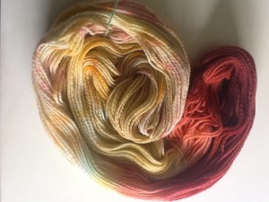 Targhee two-ply, dyed with a jawbreaker, tic-tacs and sprinkles, then gradient dyed with red-to-blue Kool-aid.